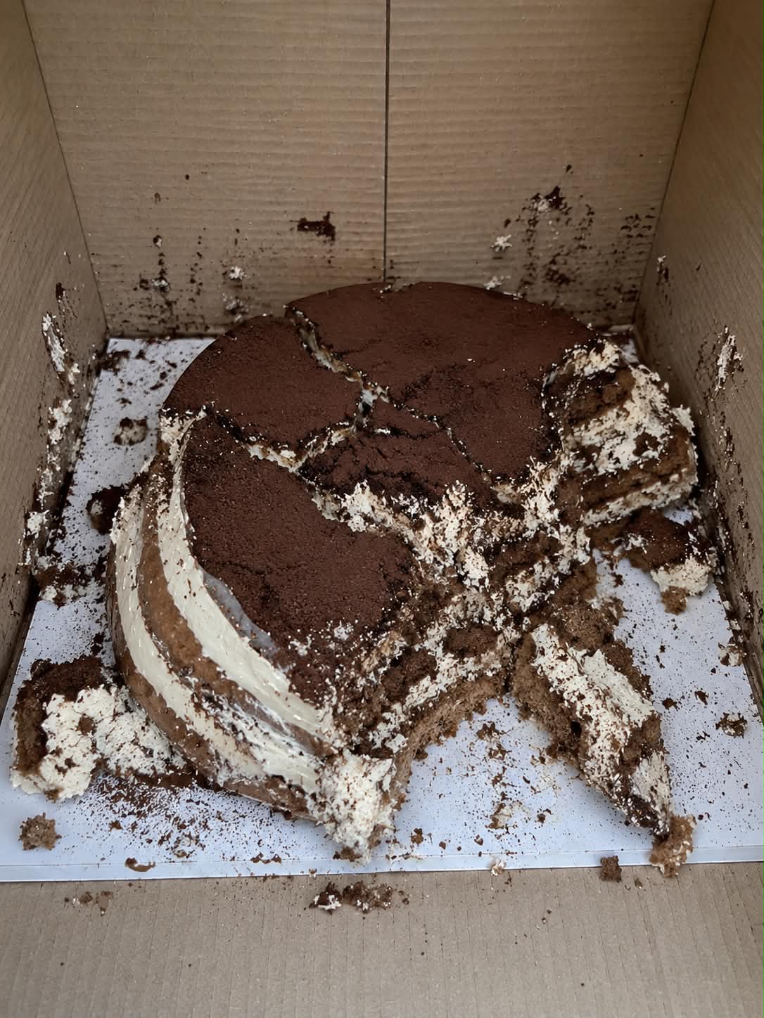 A cake damaged in transit inside its delivery box