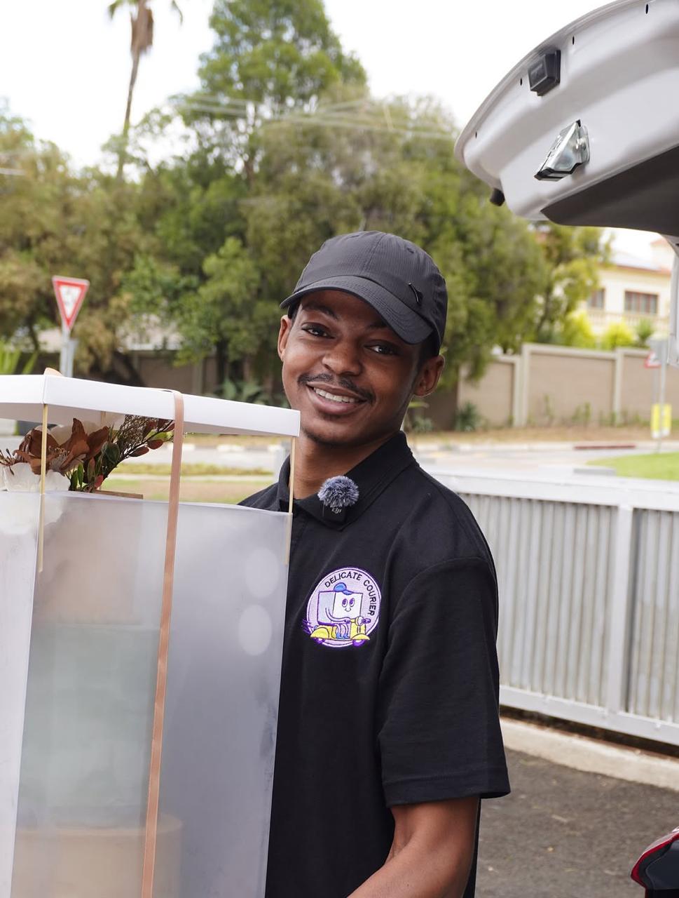 Delicate Courier driver carrying a boxed delivery
